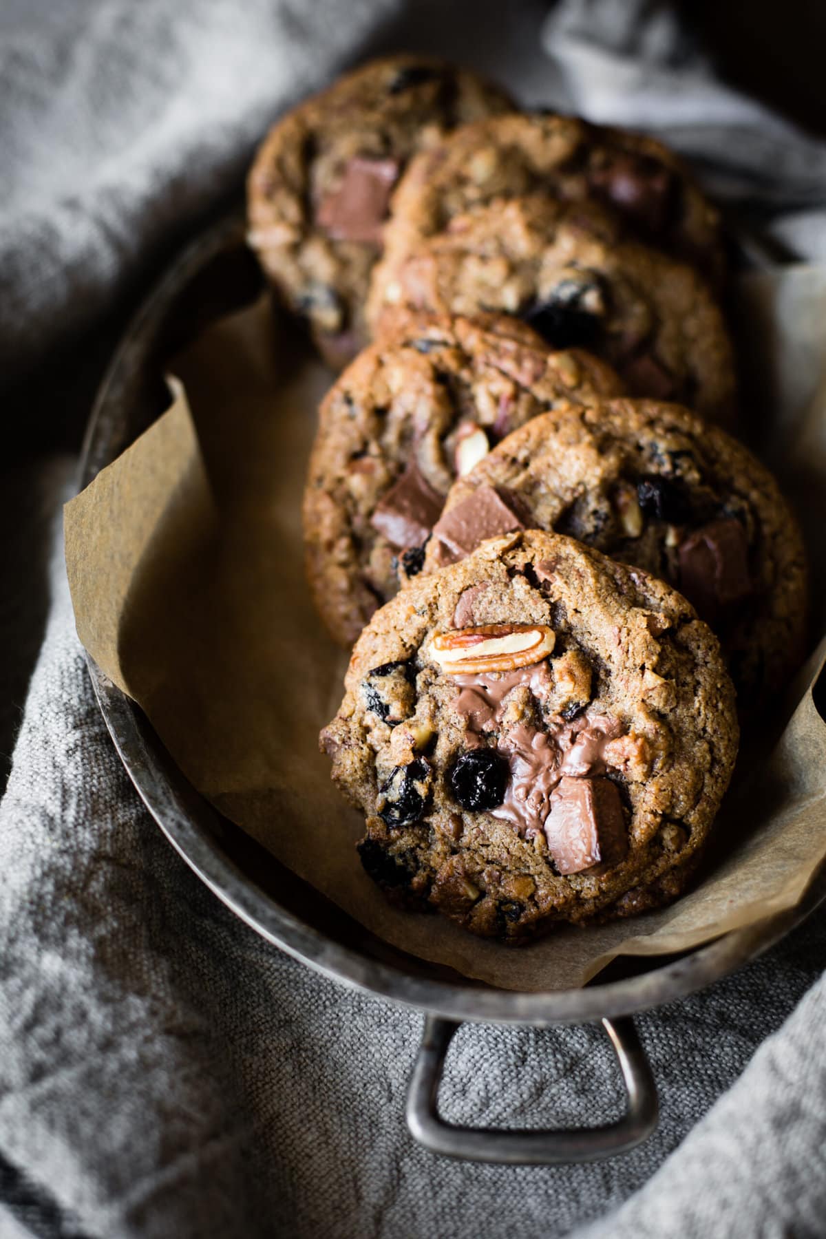 chestnut flour chocolate chip cookies are stacked in a metal pan